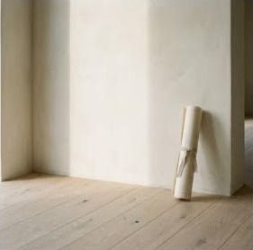 Empty room with a rolled plan leaning against the wall